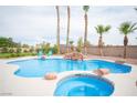 Beautiful backyard pool with waterfall feature, spa and desert landscaping in a private setting at 5815 Pristine Falls Ave, Las Vegas, NV 89131