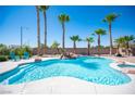 Resort-style pool and spa surrounded by lush landscaping and tall palm trees create a private oasis at 5815 Pristine Falls Ave, Las Vegas, NV 89131