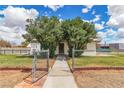 Charming home featuring mature trees, a chain-link fence, and a paved walkway to the front door at 5906 Bunch St, Las Vegas, NV 89122