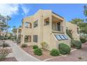 Beige two-story exterior with desert landscaping, patio, and a stairway to the 2nd level with black railings at 601 Cabrillo Cir # 754, Henderson, NV 89015