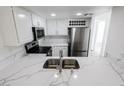 Bright kitchen featuring stainless steel appliances, marble countertops, white cabinetry, and stainless steel sink at 601 Cabrillo Cir # 754, Henderson, NV 89015