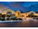 Attractive home featuring a brick driveway, mature landscaping, and stylish exterior lighting at 6373 Bridal Cave Ave, Las Vegas, NV 89131
