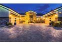 Beautiful facade featuring a brick driveway leading to a home with symmetrical garages and welcoming front entrance at 6373 Bridal Cave Ave, Las Vegas, NV 89131