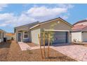 Lovely single-story home with a two-car garage and a beautifully landscaped front yard at 6755 Violet Cascade Ave, Las Vegas, NV 89156