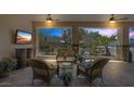 Cozy outdoor patio with comfortable seating, ceiling fans, and a view of the garden at 7687 W Pebble Rd, Las Vegas, NV 89113