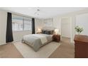 Comfortable bedroom with a ceiling fan, a large window, and neutral decor at 7901 Idledale Ct # 102, Las Vegas, NV 89145