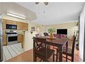 Dining area with table and seating for four, adjacent to an open kitchen with modern appliances at 7901 Idledale Ct # 102, Las Vegas, NV 89145