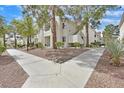 Condominium complex with well-maintained landscaping and walking path at 7901 Idledale Ct # 102, Las Vegas, NV 89145