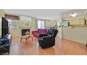 Spacious living room with fireplace, wood floors and an open concept at 7901 Idledale Ct # 102, Las Vegas, NV 89145