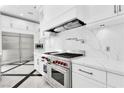 Modern kitchen featuring stainless steel appliances, white cabinets, and marble countertops at 9 Greely Club Trl, Henderson, NV 89052