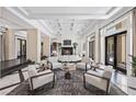 Elegant living room boasting coffered ceilings, a fireplace, and ample seating for entertaining guests at 9 Greely Club Trl, Henderson, NV 89052
