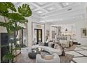 Bright, open living room with high ceilings, modern furnishings, and seamless flow to kitchen at 9 Greely Club Trl, Henderson, NV 89052