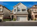 Charming two-story home featuring stone accents, a two-car garage, and manicured landscaping at 9173 Whitekirk Pl, Las Vegas, NV 89145