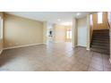 Spacious living room featuring tile floors, neutral paint, and staircase at 9173 Whitekirk Pl, Las Vegas, NV 89145