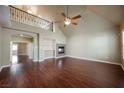Open living room with fireplace, hardwood floors and vaulted ceilings at 9173 Whitekirk Pl, Las Vegas, NV 89145