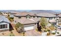 Overhead angle showing the property with a 2-car garage, tile roof, and desert landscaping at 9370 Burning Sage Ave, Las Vegas, NV 89149