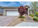 Charming single story home featuring a two-car garage and meticulously landscaped front yard at 9370 Burning Sage Ave, Las Vegas, NV 89149