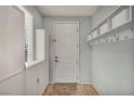 Organized mudroom with white cabinets, storage shelves and coat hooks at 9370 Burning Sage Ave, Las Vegas, NV 89149