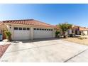 Exterior view of a charming single-story home featuring a three car garage and desert landscaping at 1185 Ponce De Leon Ave, Las Vegas, NV 89123