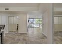 Bright living room featuring sliding glass doors to balcony and neutral tile flooring at 725 N Royal Crest Cir # 214, Las Vegas, NV 89169