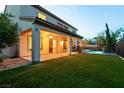 Expansive backyard featuring lush green grass, a covered patio, and a refreshing pool area at 7416 Redhead Dr, North Las Vegas, NV 89084