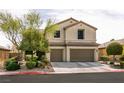 Charming two-story home features a three-car garage and well-manicured landscaping at 7416 Redhead Dr, North Las Vegas, NV 89084