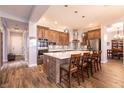 Modern kitchen with stainless steel appliances, large island, and stylish pendant lighting at 7416 Redhead Dr, North Las Vegas, NV 89084