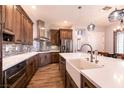 Gourmet kitchen with custom cabinets, a farmhouse sink and stainless steel appliances at 7416 Redhead Dr, North Las Vegas, NV 89084
