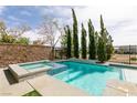 Backyard swimming pool and spa with mature landscaping and privacy fence at 7416 Redhead Dr, North Las Vegas, NV 89084