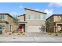 Charming two-story home with a desert landscaped front yard and modern architectural design at 9068 Lennon Ln, Las Vegas, NV 89113