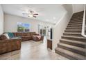 Spacious living room flows to the staircase, providing seamless access to upper levels at 9068 Lennon Ln, Las Vegas, NV 89113
