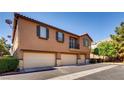 Exterior view of a home with multiple garages at 9115 Canoga Canyon Ct # 102, Las Vegas, NV 89149