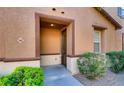 Inviting front entrance with stone accents and landscaped bushes at 9115 Canoga Canyon Ct # 102, Las Vegas, NV 89149
