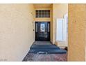 Inviting front entry with a black door, glass accents, a stylish light fixture, and brick steps at 10021 Skipper Ct, Las Vegas, NV 89117