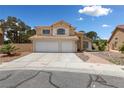 Charming two-story home with a three-car garage, neat landscaping, and a paved walkway to the entrance at 10021 Skipper Ct, Las Vegas, NV 89117
