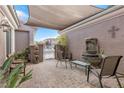 Charming patio area with tiled floor, water fountain, seating, and decorative accents at 10024 Scenic Walk Ave, Las Vegas, NV 89149