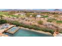 A luxurious pool and golf course view, complemented by chaise lounges, lush greenery, and open space at 15 Rue Du Rivoli Pl, Henderson, NV 89011