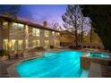 Backyard pool and spa, and covered patio with large grassy yard in the background at 4156 Balmoral Castle Ct, Las Vegas, NV 89141