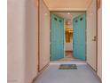 Inviting front entrance features stylish, light-blue double doors and a colorful welcome mat at 7908 Morning Gallop Ct, Las Vegas, NV 89131