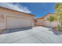 This property boasts a three-car garage with plenty of driveway space on a sunny day at 7908 Morning Gallop Ct, Las Vegas, NV 89131