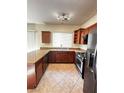 Traditional kitchen equipped with stainless steel appliances, granite counters, and wood cabinets at 8920 Appellation Ave, Las Vegas, NV 89148