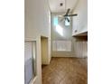 Bright living room with high ceilings, tile floors, and large windows, creating a comfortable space at 8920 Appellation Ave, Las Vegas, NV 89148