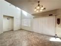Spacious living room featuring tile flooring, large windows, and a modern light fixture at 8920 Appellation Ave, Las Vegas, NV 89148
