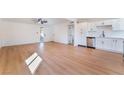 Open-concept living area with wood floors seamlessly connects to the kitchen at 2878 El Cajon St, Las Vegas, NV 89169
