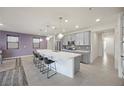 Modern kitchen with a large island, stainless steel appliances, and sleek gray cabinetry at 605 Cadence Vista Dr, Henderson, NV 89011