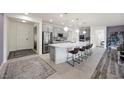 Modern kitchen with stainless steel appliances, gray cabinets, and a large island with barstool seating at 605 Cadence Vista Dr, Henderson, NV 89011