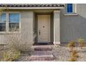 Inviting front door is enhanced by a decorative brick walkway and well-maintained landscaping at 10290 Lodge Pine Ave, Las Vegas, NV 89166