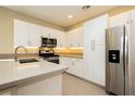 Modern kitchen with sleek white cabinets, stainless steel appliances, and ample counter space at 11236 Rainbow Peak Ave # 210, Las Vegas, NV 89135