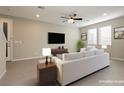 Comfortable living room boasts neutral tones, TV, and lots of natural light at 11236 Rainbow Peak Ave # 210, Las Vegas, NV 89135