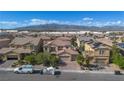 Beautiful two-story home featuring a lush lawn, mature trees, and a spacious three-car garage at 1212 Equator Ave, North Las Vegas, NV 89032